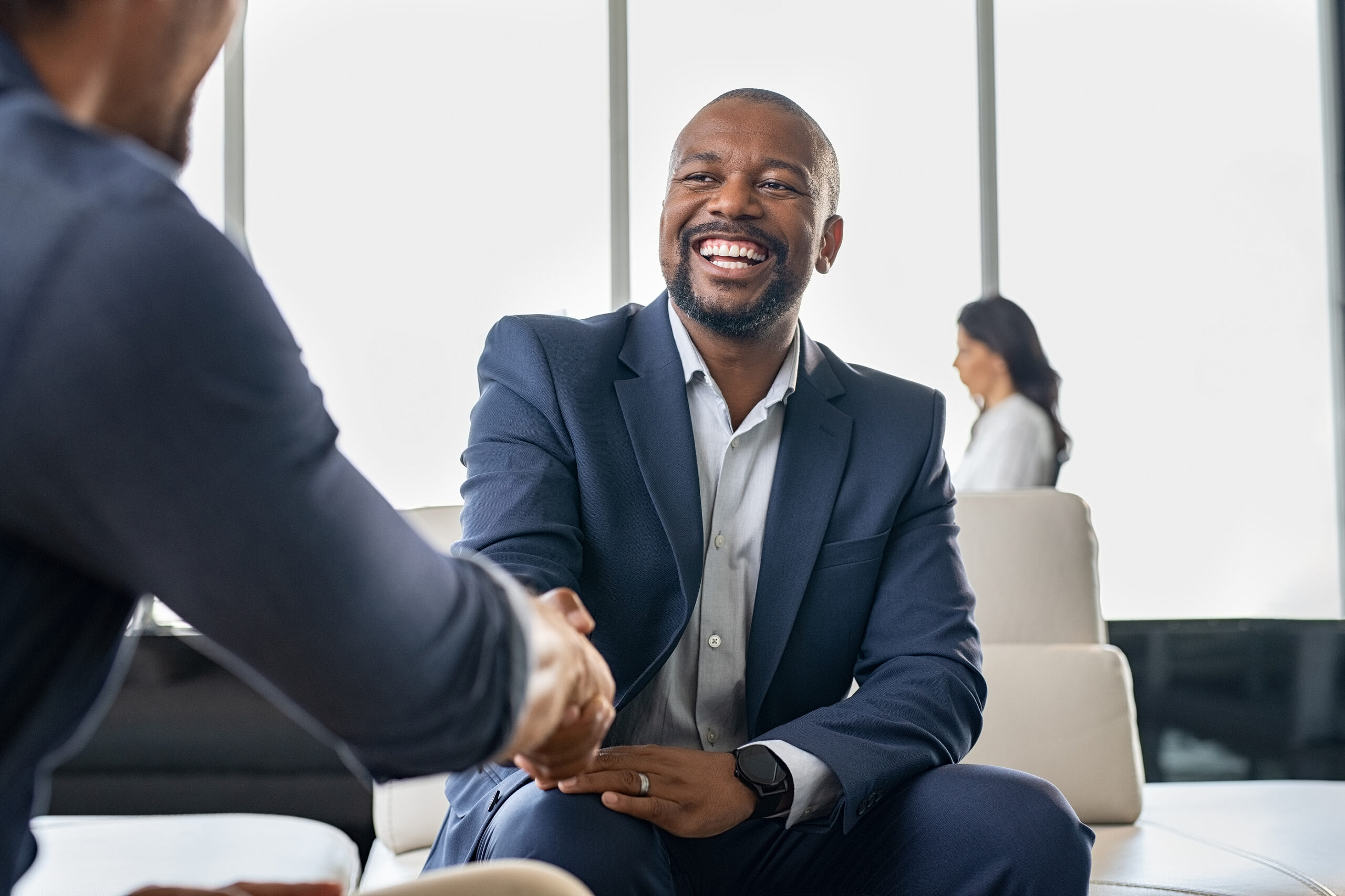 Two happy mature business men doing handshake