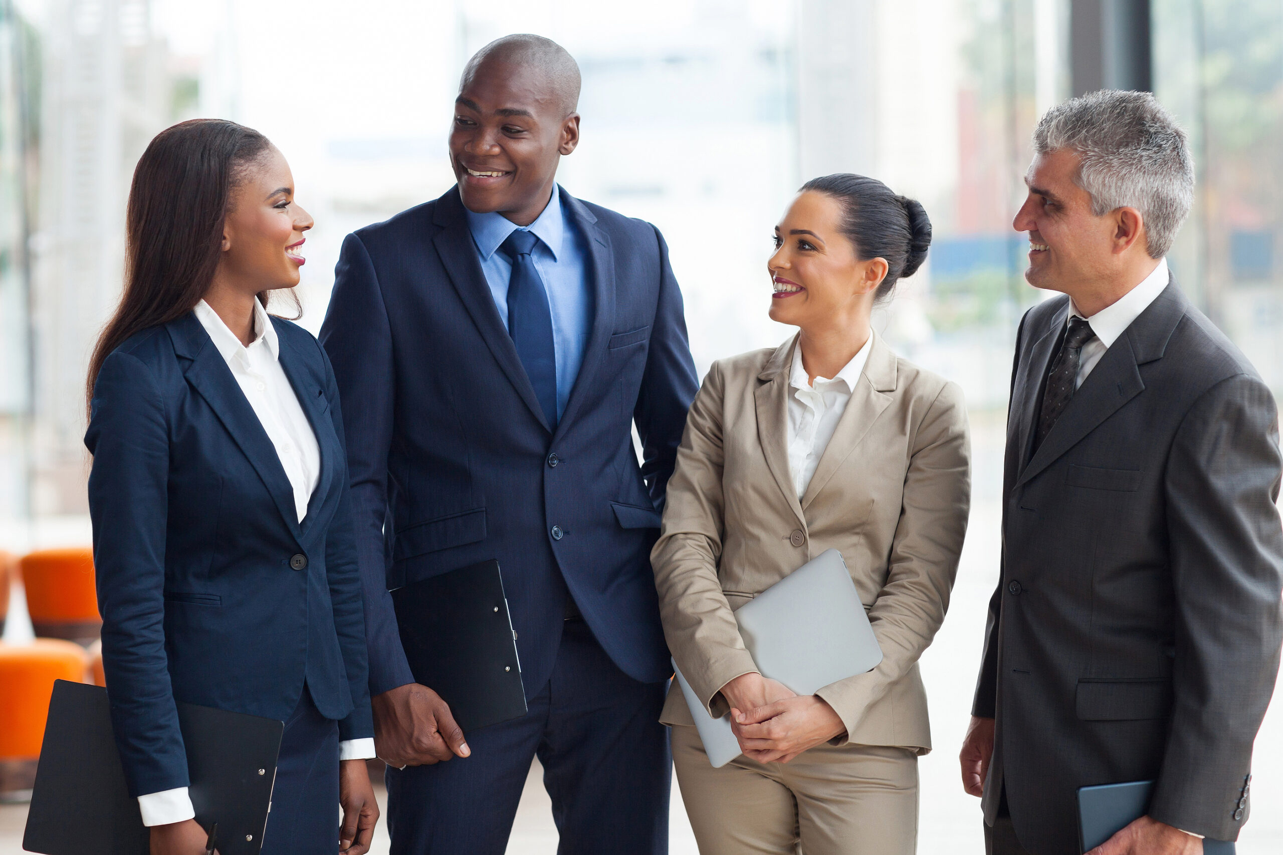 group of business people chatting after the meeting